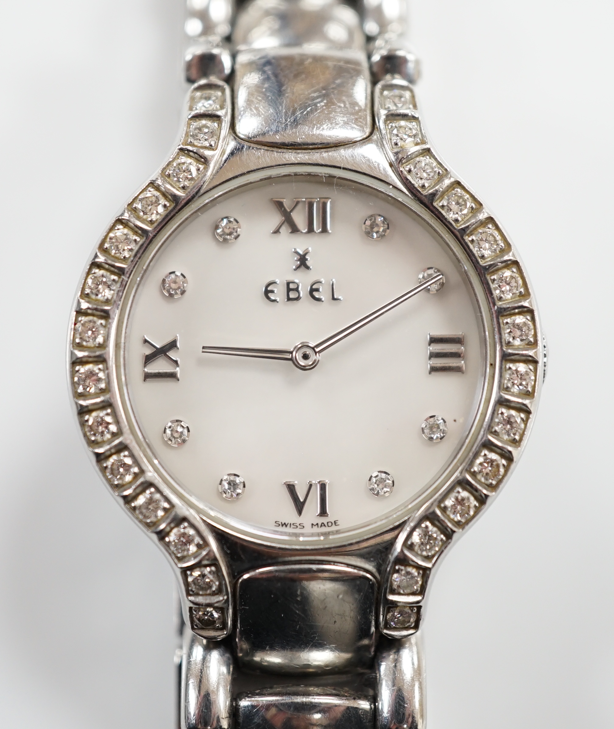 A lady's 2001 stainless steel Ebel quartz wrist watch, with diamond set bezel, mother of pearl dial and diamond dot markers, on a stainless steel bracelet, with box and guarantee.